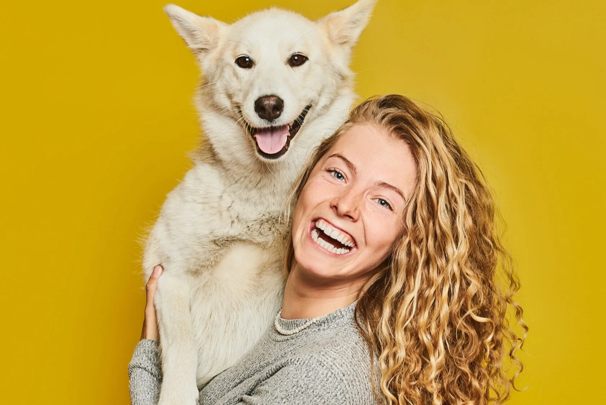 happy-woman-smiling-with-white-dog-erik-pinkerton